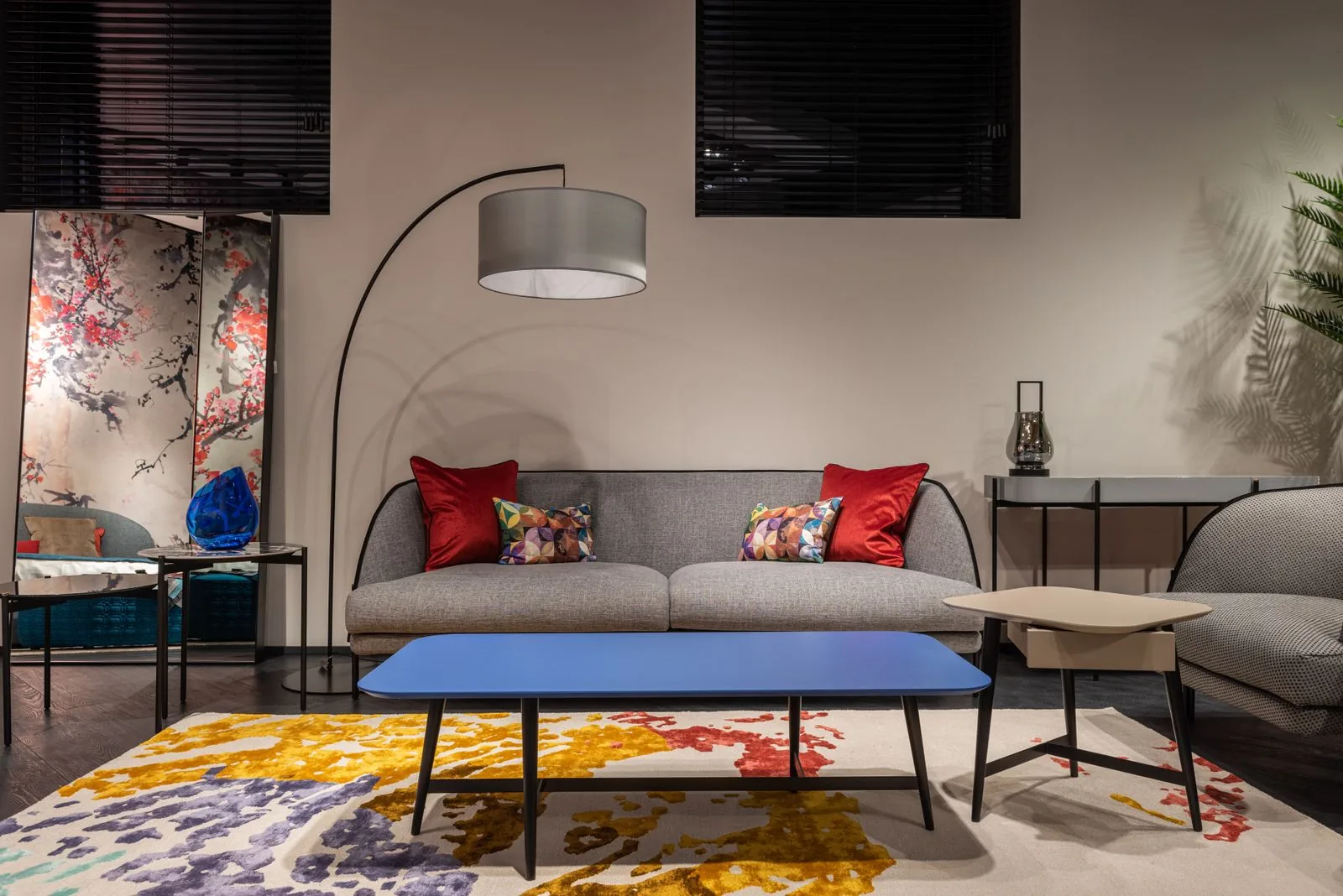 Living room with a large area rug under a sofa and armchair, framing the seating area
