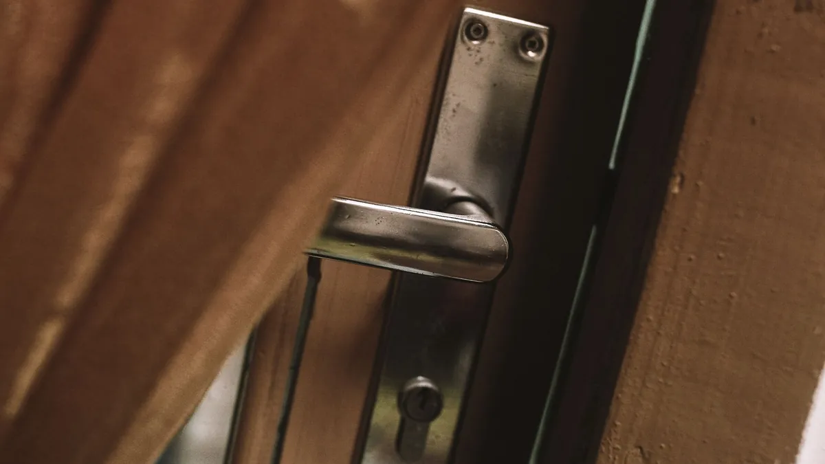 Interior door standing slightly ajar in a wooden frame